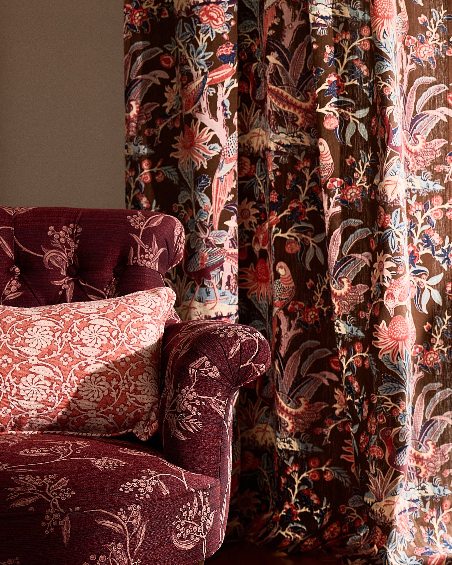 Utopia Goods Arcadia Mocha Furnishing Linen: burgundy upholstered chair with botanical print and matching curtains in warm interior