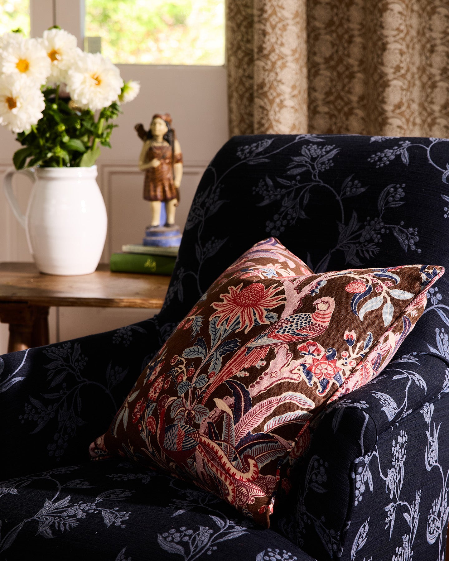 Utopia Goods Arcadia Mocha Medium Cushion Cover: brown floral printed linen pillow on dark botanical patterned sofa in styled room