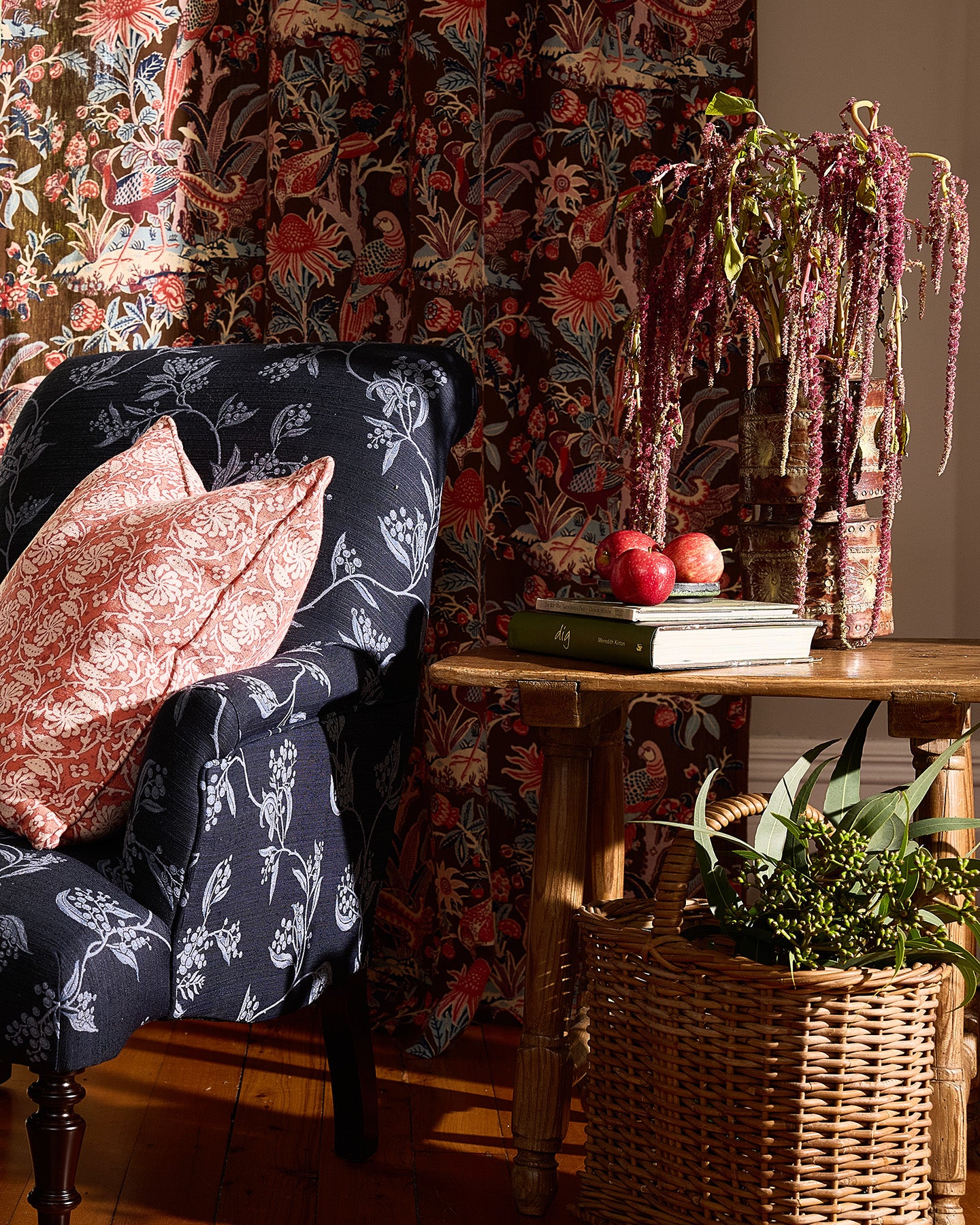 Utopia Goods Arcadia Mocha Furnishing Linen: rich botanical wallpaper with birds and flowers in burgundy tones behind upholstered chair