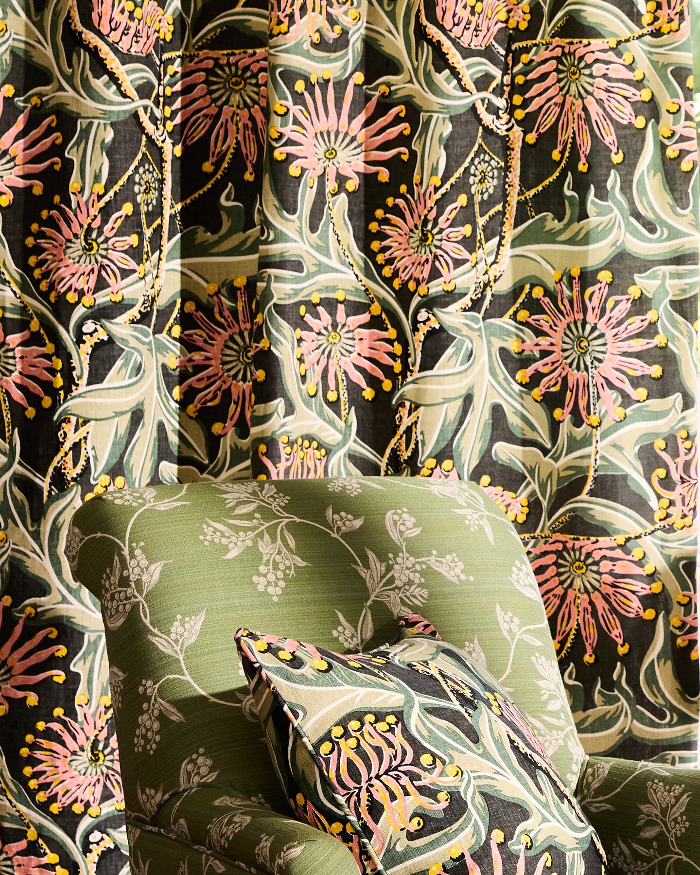 Utopia Goods Firewheel Earth Furnishing Linen: green upholstered chair with botanical print against bold floral wallpaper backdrop