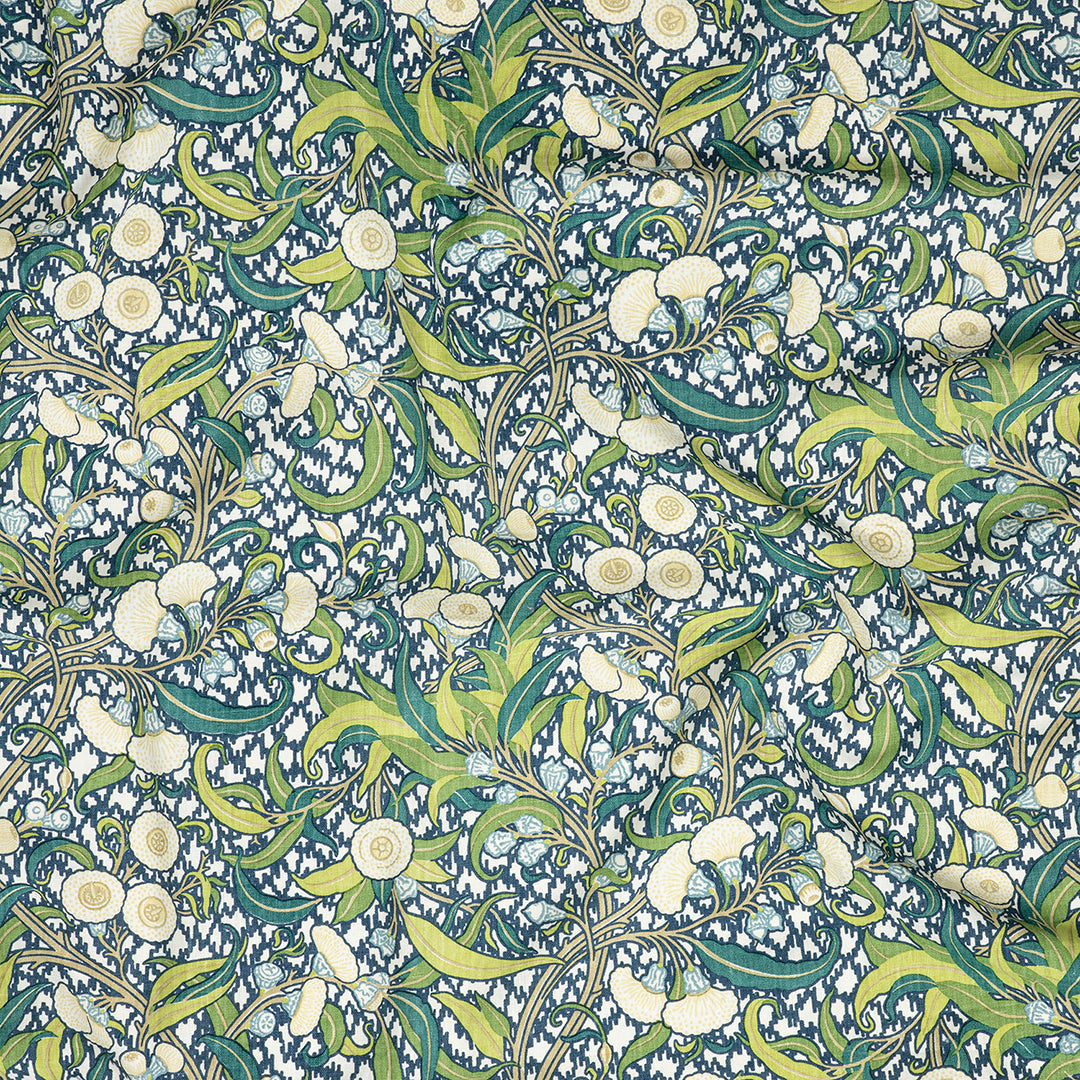 Utopia Goods: decorative fabric pattern with flowing green vines, cream flowers, and blue speckled background