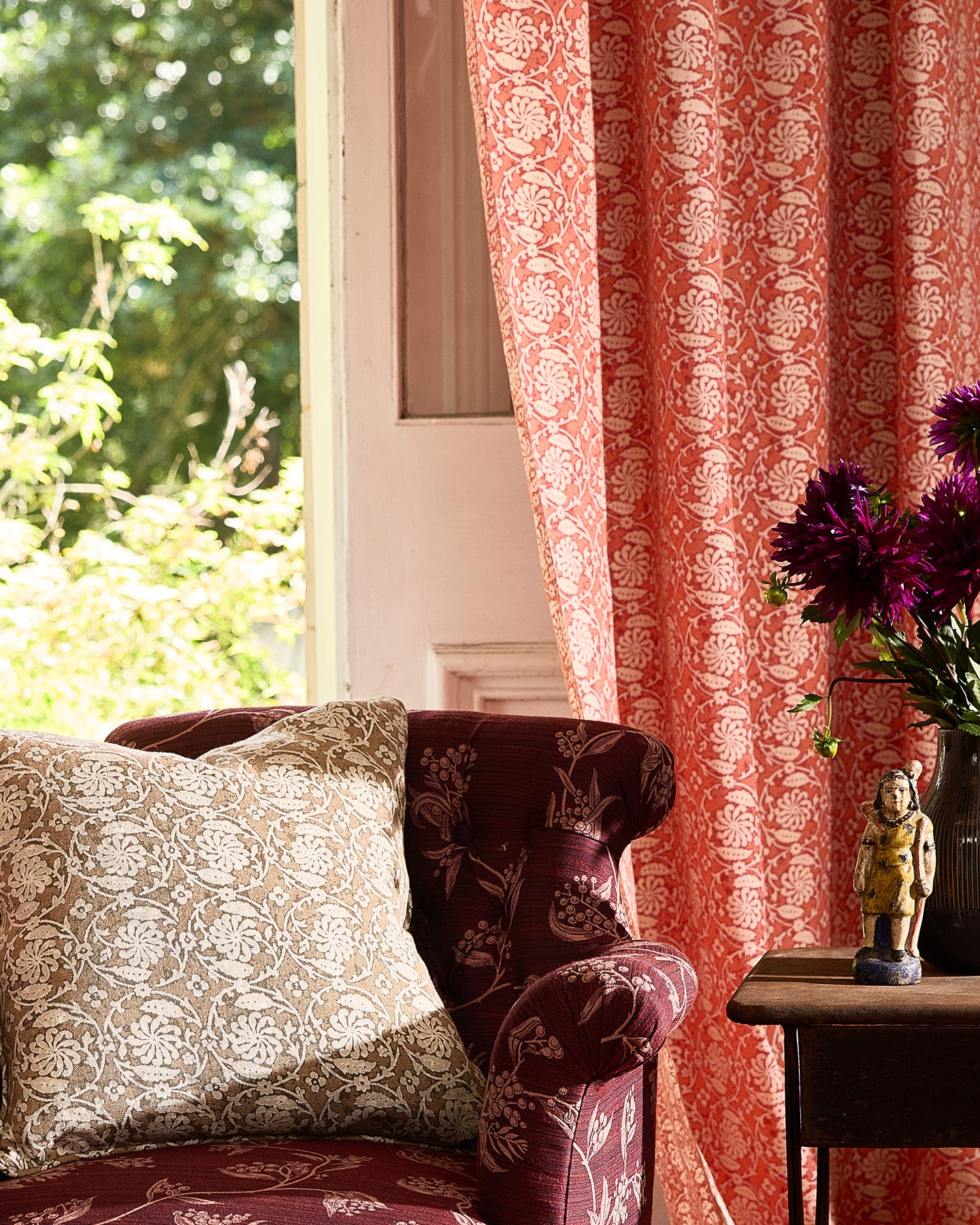 Utopia Goods Pinwheel Sepia Medium Cushion Cover: cream linen cushion with intricate paisley pattern on burgundy chair by window