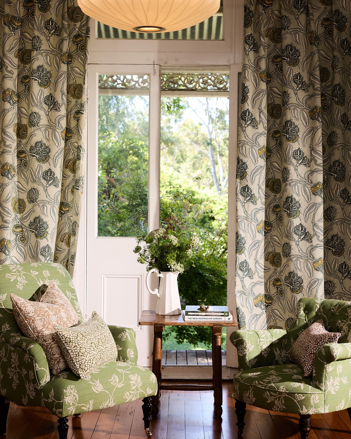 Utopia Goods Youngiana Grey Furnishing Linen: botanical floral curtains in cream and grey flanking French doors with green chairs