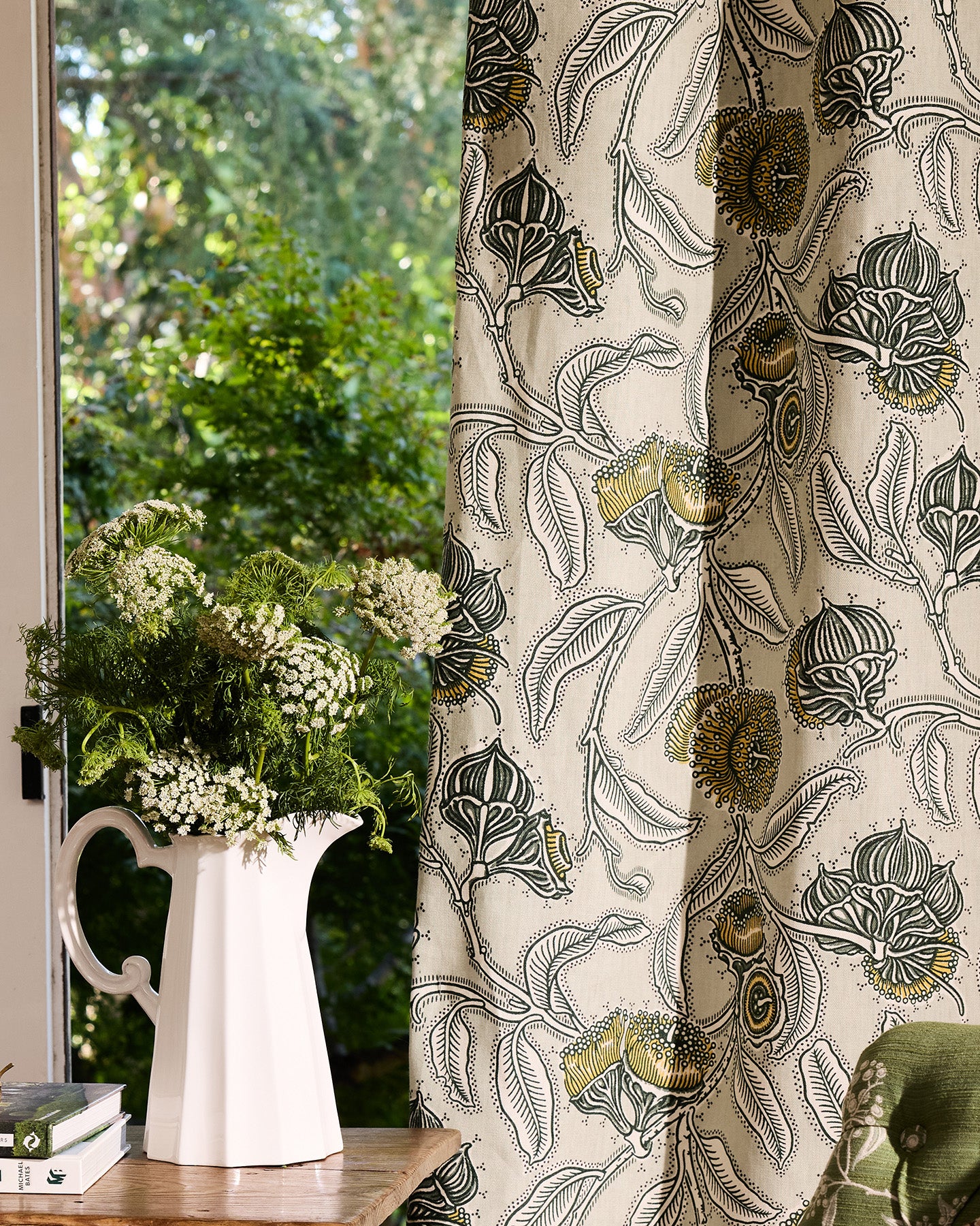 Utopia Goods Youngiana Grey Furnishing Linen: botanical print curtain with paisley and floral motifs beside window with flower vase