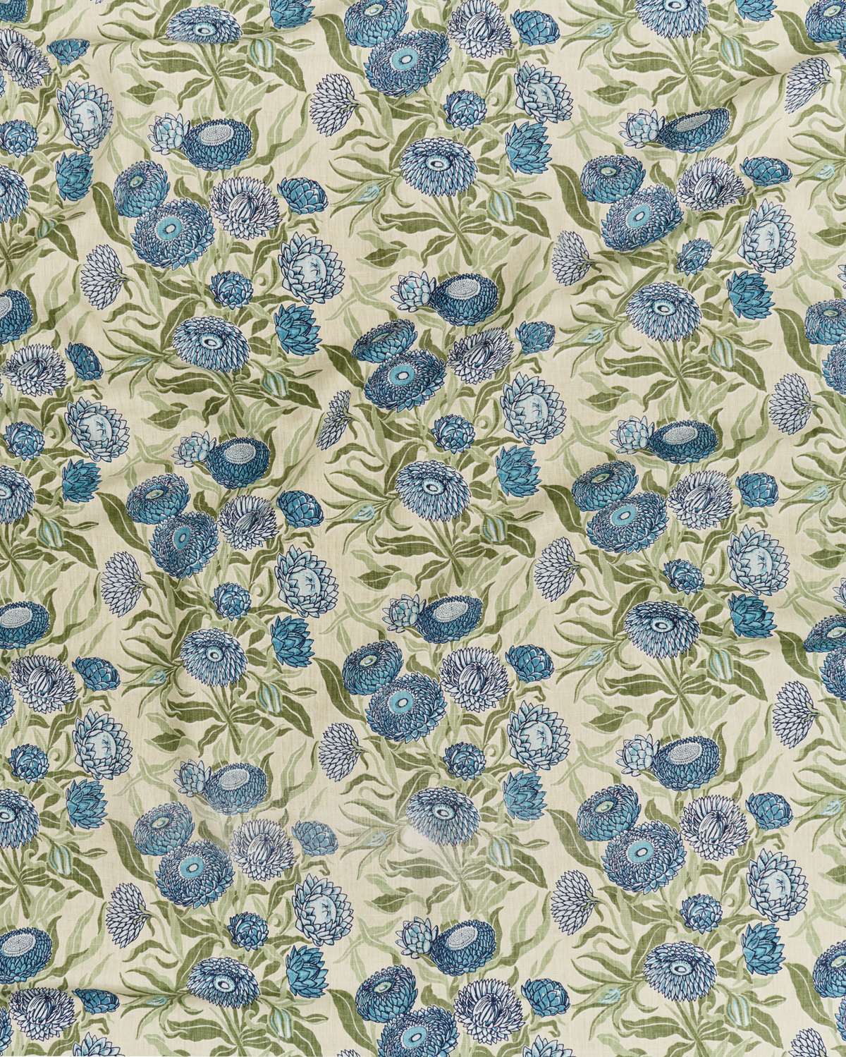 A close-up of a linen Everlasting daisy folower pattern fabric featuring blue flowers with sage green leaves on a warm cream background.