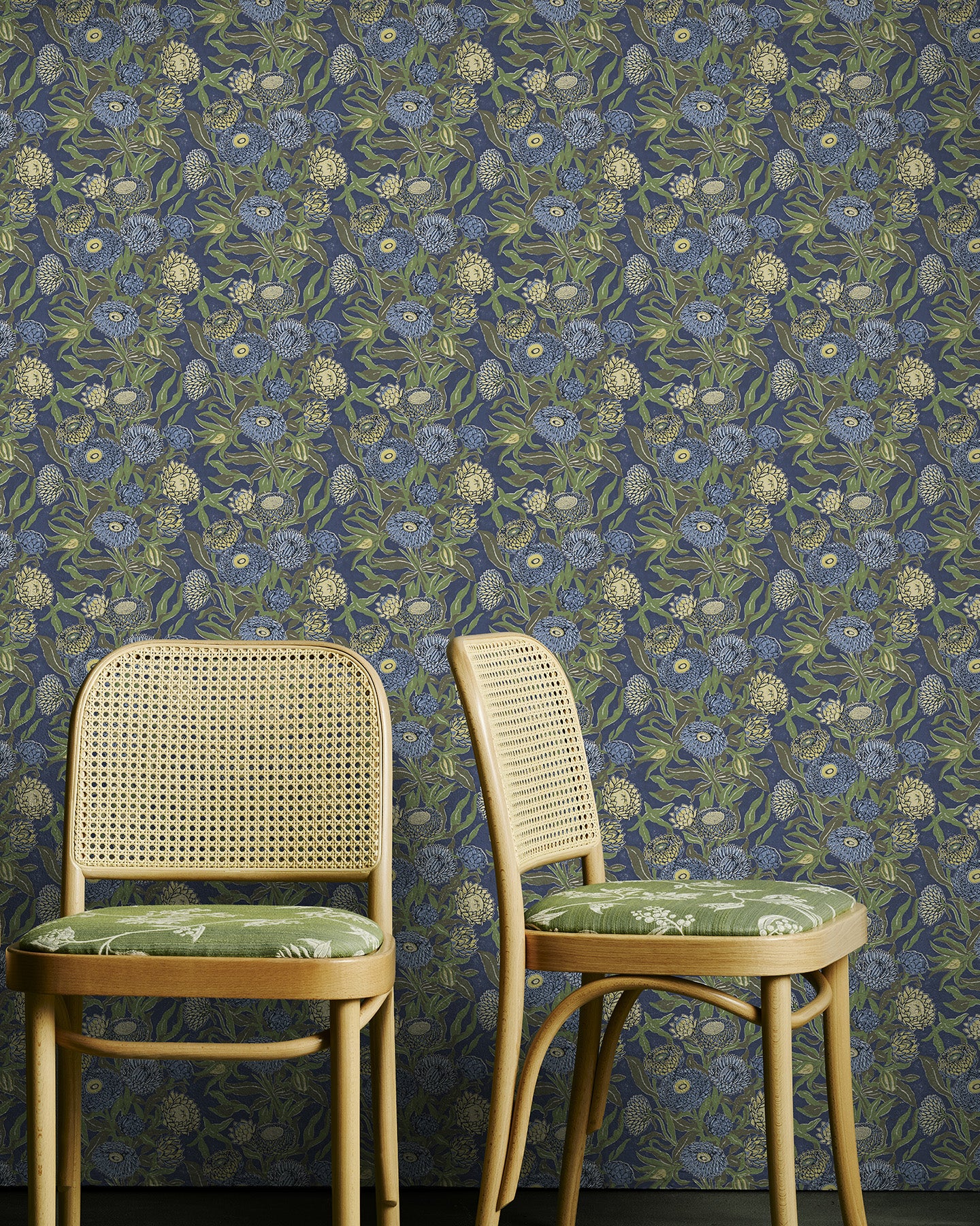 Wattle Green chairs in front of Utopia Goods Blue green wallpaper - Designer floral wallpaper-Everlasting Inky Blue Wallpaper