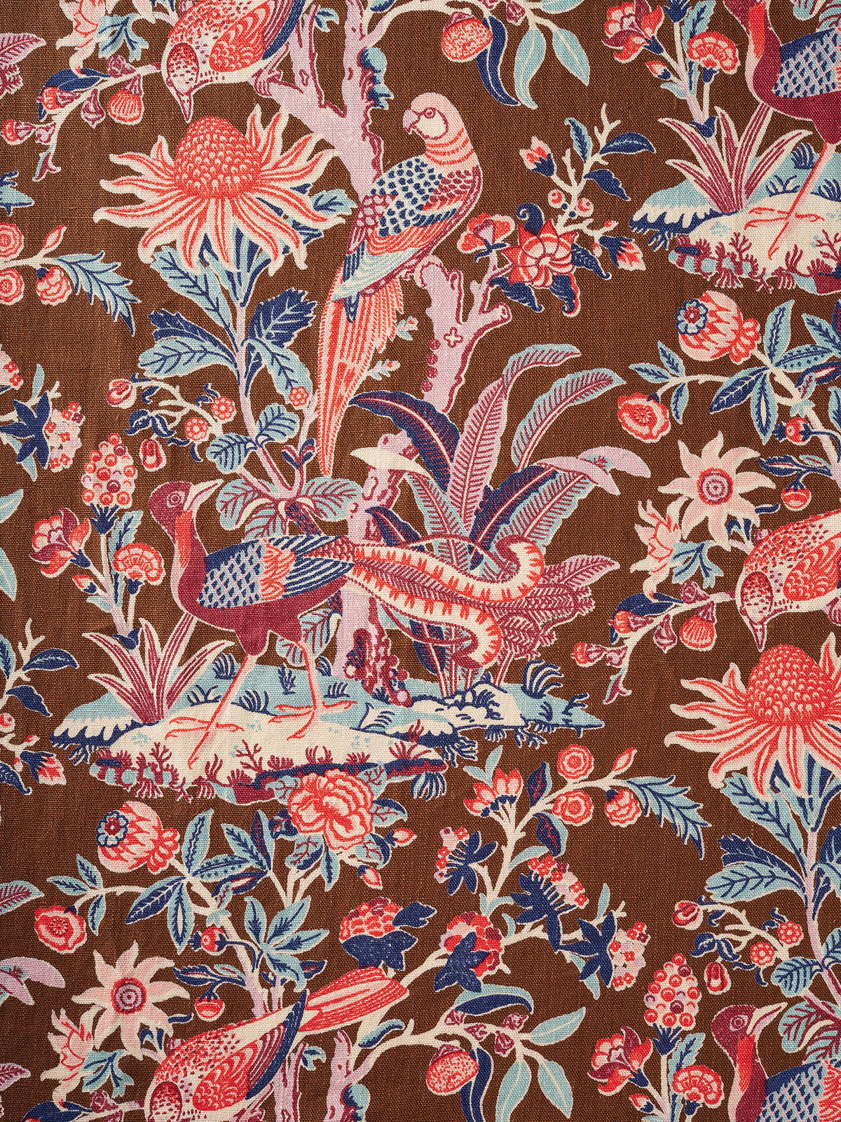 Utopia Goods - Arcadia Mocha linen swatch. A close-up shot a brown fabric with a classic French Toile pattern featuring parrots, peacocks, flowers, and foliage in red, blue, and cream.