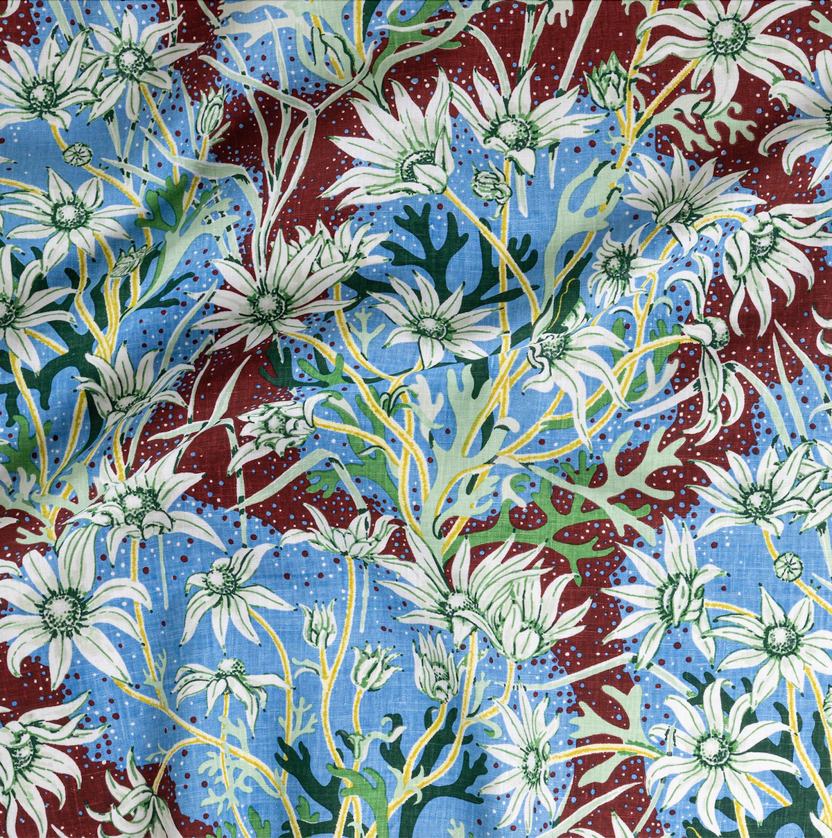 Utopia Goods: colorful floral fabric pattern with white daisies on blue and burgundy background with yellow accents